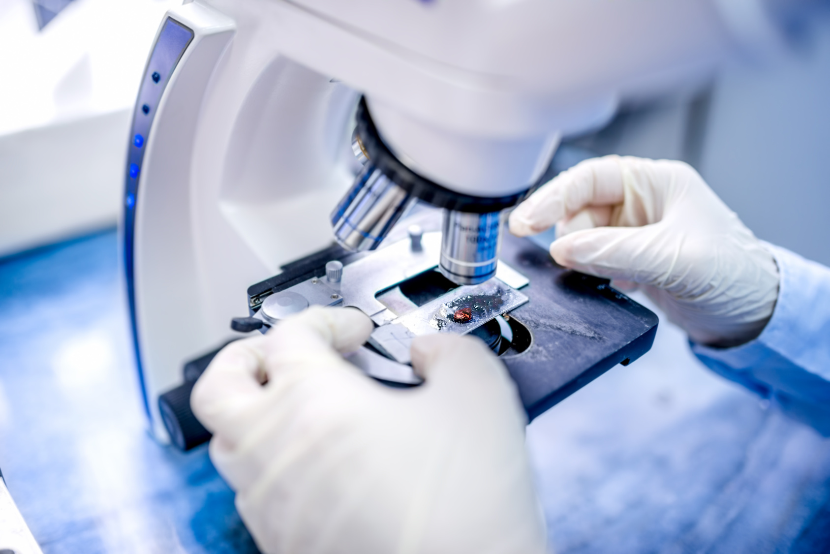 Close Up Of Scientist Hands With Microscope, Examining Samples close-up of scientist hands with microscope, examining samples and liquid
